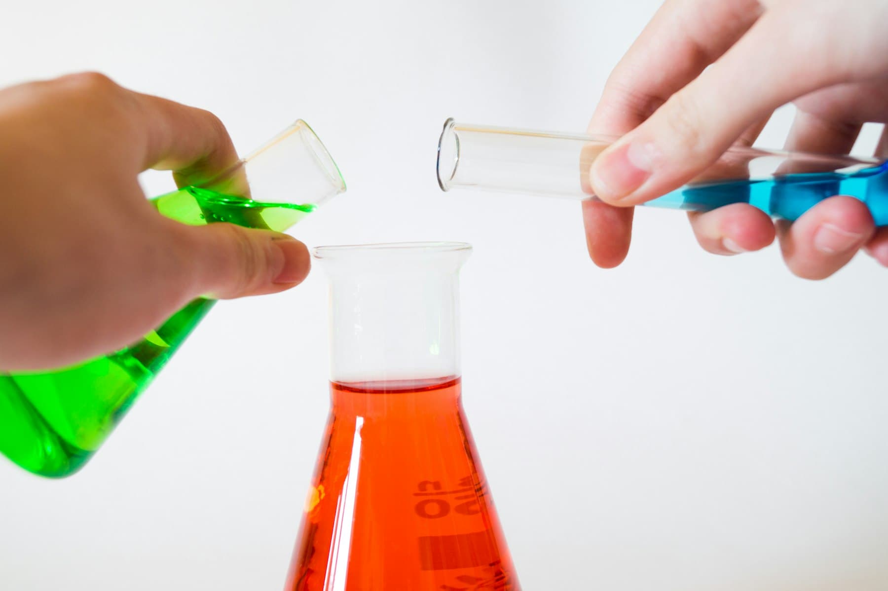 Hands working with laboratory glassware
